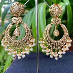 A pair of chandbali earrings in 925 silver with gold plating. Metal: 92.5% silver Setting stones: Real freshwater pearls Beads: Real freshwater pearls Weight - 30 GMs Height - 7.8 cm Width- 3.75 cm Jadau Chandbali Earrings, 22k Gold Jewelry Necklaces, Jadau Jewellery, 22k Gold Jewelry, Curl Hair, Chandbali Earrings, Pearl Necklace Set, Gold Jewelry Necklace, Freshwater Pearls Earrings