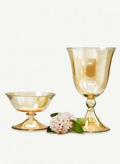 two gold dishes with flowers on the side