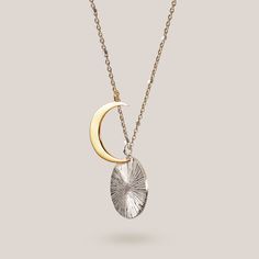 Featuring an 18k gold vermeil crescent moon eclipsing a hand-engraved sterling silver disc, the Eclipse Necklace is made for the lovers of the night sky. The two brilliant pendants hang independently from a 18" - 20” two tone satellite chain or sparkling sterling silver cable chain. Our best selling necklace for 5+ years. Celestial Moon Phase White Gold Necklace, Celestial White Gold Moon Phase Necklace, Celestial Moon Necklace In White Gold, Sterling Silver Moon Necklace With Coin Pendant, Moon Shaped Sterling Silver Necklace With Coin Pendant, Silver Moon Necklace With Coin Pendant, Sterling Silver Moon Charm Medallion Jewelry, Sterling Silver Medallion Jewelry With Moon Charm, Sterling Silver Medallion With Moon Charm