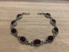 Lovely garnet and sterling silver bracelet. The bracelet has 9 individual garnet in an oval shape.  The bracelet measure 21 cm long and it is almost 0.8 cm wide. The bracelet can be  easily  adjusted from 21 cm to 17 cm.  The high quality of our stones is what it makes this bracelet so precious.  A perfect present for her on any occasion St Valentine Day, Birthday, Anniversary, Travelling or Christmas. Your bracelet will be pack in our lovely Kallpa bag. If the destination is outside UK the pack Edgy Jewelry, Red Bracelet, St Valentine, Present For Her, Garnet Bracelet, Red Bracelets, Dope Jewelry, Garnet Jewelry, Bracelet Chain