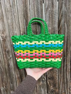 Adorable green plastic woven purse. Perfect for spring or even an Easter basket. Retro Green Shopping Bag, Green Rectangular Bags For Spring, Green Rectangular Bag For Spring, Green Woven Vacation Bag, Green Rectangular Spring Bags, Green Straw Bag For Spring Shopping, Green Bags With Braided Handles For Spring, Green Beach Bags For Spring, Green Spring Beach Bags