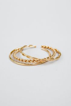 Introducing our stunning Neva cuff set, a playful and stylish addition to any jewelry collection. This set of stackable bracelets is expertly crafted from durable stainless steel and finished with a radiant 18k gold plating, creating a beautiful and eye-catching look.The Neva cuff set includes multiple bracelets that can be worn together for a bold and striking look or separately for a more subtle effect. The versatility of this set means that you can mix and match to create a variety of differe Stackable Double Band Gold Bracelets, Gold Stackable Double Band Bracelets, Trendy Gold-plated Tarnish-resistant Bangle, Gold Stackable Stainless Steel Bracelets, Gold Stainless Steel Stackable Bracelets, Gold Stackable Cuff Bracelet For Everyday, Chic Gold Stackable Cuff Bracelet, Adjustable Modern Jewelry With Tarnish Resistance, Adjustable Modern Twist Tarnish-resistant Jewelry