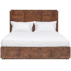 a bed with two pillows on top of it and white sheets in front of the headboard