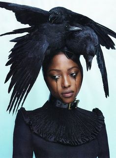 the cover of love magazine featuring a woman with black feathers on her head and an image of