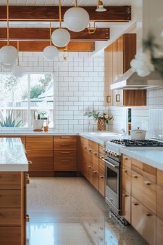 a large kitchen with wooden cabinets and white tile flooring on the walls, along with marble counter tops