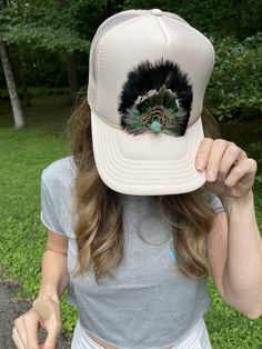 * * *Handmade feather trucker with authentic turquoise stone for women and men* * * We make our Feather Truckers from 100% sustainably sourced feathers from our friends' wild game hunts. Each hat is meticulously handcrafted and the feathers (primarily we use turkey and pheasant) are hand-selected for quality. Due to the nature of feathers, every piece is unique and no two will ever look alike. We use Otto brand trucker SnapBack hats and authentic stones and gems. We want our customers to be completely happy with their product while providing these pieces at an affordable price.  Please contact me if you would like to place a custom order, using our feathers or your own (for added personalization and meaning).   **Please note that sizes of the crowns on each hat vary** Thank you for visitin Feather Hats, Lainey Wilson, Wild Game, Hats Snapback, Post Malone, Pheasant, Look Alike, Turquoise Stone, Snapback Hats