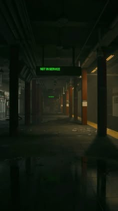 an empty subway station at night with neon signs