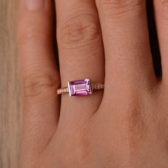 It is a lab pink sapphire ring. The main stone is 5*7 mm emerald cut.weight about 1.2 carats. The metal is 14k rose gold in the picture, I also can make it in 14k white/yellow gold You can also go to my shop Home for more elegant rings: https://www.etsy.com/shop/godjewelry?ref=hdr_shop_menu Customization is always welcome and please feel free to contact with me if you have any design ideas! Pink Emerald Cut Ruby Ring In Fine Jewelry, Emerald Cut Pink Ruby Ring In Fine Jewelry Style, Rose Gold Emerald-cut Sapphire Ring With Accent Stones, Emerald-cut Rose Gold Sapphire Ring With Accent Stones, Emerald-cut Sapphire Ring In Rose Gold With Accent Stones, Fine Jewelry Pink Sapphire Ring With Emerald Cut, Pink Emerald Cut Sapphire Ring In Fine Jewelry Style, Fine Jewelry Pink Emerald-cut Sapphire Ring, Pink Emerald Cut Sapphire Ring Fine Jewelry