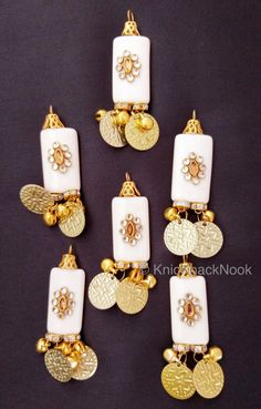 This listing is for a lovely White And Gold Beaded Tassels  With Gold Coins Latkan, Kundan Beads, Belly Dancing, Indian Latkans, Beaded Danglers. This is a very special KnicKnackNook find which you will not find anywhere else. End to End Length: 65 mm x 15 cm This listing is for 2 pieces. Great for jewellery making, embellishing bags, clutches, jeans, dresses, table topper, scrap-booking and many other crafts and sewing projects. Tassels Fashion Clothing, Bridal Trim, Rakhi Design, Easter Fabric, Embellished Bags, White Tassel, Tassels Fashion, Floral Craft, Belly Dancing