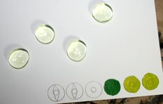 four circles are shown on the paper with different shapes and sizes to make it look like they're made out of clay