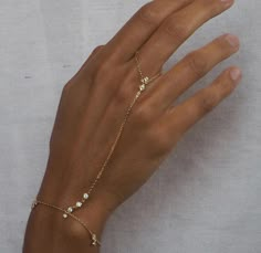 Gold Dainty Hand Chain Bracelet - Ring Bracelet - Delicate Hand Chain - Silver Finger Bracelet - Minimalist Hand Jewelry - Trendy Hand Chain About this item: Elevate your elegance with this exquisite Gold Dainty Hand Chain Bracelet, perfect for those who appreciate minimalist beauty. This delicate bracelet features a fine gold chain with an attached finger ring, designed to gracefully wrap around your hand. Its trendy and subtle style makes it ideal for adding a touch of sophistication to any lo Bracelet With Ring Attached Hand Chain, Finger Ring Bracelet, Finger Bracelets, Hand Chain Bracelet, Gold Silver Jewelry, Ring Bracelet Chain, Minimalist Beauty, Wrist Jewelry, Bracelet Minimalist