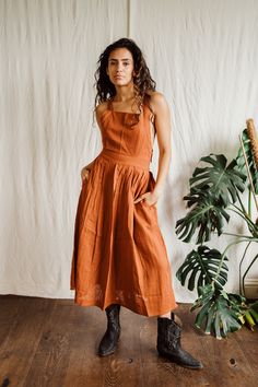 Rust Cara Pinny dress. Beautiful adjustable cross back with elastic waist band.  Pockets High grade lightweight cotton Suitable for size 6-12 Casual Backless Dress With Lace-up Back, Casual Cotton Sundress With Smocked Back, Cotton Sundress With Smocked Back For Casual Occasions, Cotton Sundress With Smocked Back For Casual Wear, Cotton Suspender Dress With Tie Straps For Day Out, Cotton Sundress With Adjustable Straps For Casual Wear, Cotton Square Neck Dress With Tie Back, Cotton Dress With Tie Back And Square Neck, Cotton Sundress With Square Neck Suspender