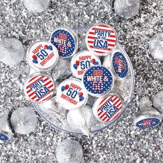 buttons with the words happy birthday and red white and blue on them in a bowl