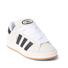 Clean and classic, the Campus '00s Athletic Shoe from adidas boasts a slick retro design with stylish versatility that still holds up today. The Campus '00s Sneaker features a smooth suede upper, soft terry lining, padded tongue and collar, and durable rubber sole with herringbone tread for all day traction. Cute Shoes Womens, Adidas Campus 00s Crystal White, Retro Adidas Shoes, Cute Adidas Shoes, Trendy Shoes Sneakers, Pretty Shoes Sneakers, Cozy Boots, Womens Adidas, White Core