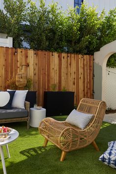 an outdoor living area with grass and furniture