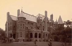 an old photo of a large brick building with turrets on it's roof and two towers