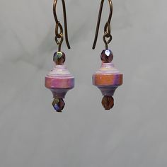 Pink and purple paper lantern - paper bead earrings My paper beads are handcrafted and unique. I select aesthetically pleasing patterned papers to create them. My paper beads are made one at a time by hand, and it takes about a week to make a batch of beads from start to finish. When creating jewelry, I balance contrasting colors, patterns, and shapes. Then, I combine glass spacer & focal beads to tie the design together. My handmade paper bead jewelry makes the perfect gift for someone who likes unique, handcrafted, one-of-a-kind jewelry. Paper Beads Jewelry, Paper Beads Earrings Ideas, Paper Bead Making, Paper Bead Jewelry Necklaces, Paper Bead Earring, Paper Bead Jewelry, Christmas Tree Earrings, Earring Tree, Handcrafted Necklace