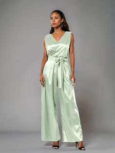 This soft satin jumpsuit features a flattering v-neck design, making it the perfect choice for mothers of the bride. Its dress pantsuit style provides comfort and elegance, while its high-quality material ensures a polished look. Stay stylish and comfortable on that special day with our jumpsuit. Dress Pantsuit, Elegant Jumpsuit, Mother Of The Groom Dress, Satin Jumpsuit, Designer Jumpsuits, Jumpsuit Elegant, Dress Pant Suit, Junior Bridesmaid Dresses, Mother Of The Bride Dress