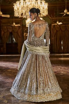 This set features a coffee brown jacket in tissue silk with delicate embroidery with bugle beads, sequin and crystal. The lehenga is in contrasting deep mustard lehenga has a broad border at the bottom. The slate tissue dupatta has a cut work border on all four sidesFrom Seema Gujral's Falaknuma collection. DELIVERY TIMEPlease allow 8-12 weeks for your outfit to arrive. FABRIC DETAILSLehenga & Jacket - Tissue Silk Dupatta - Tissue organza Professional cleaning only. Hand Embellished Lehenga For Wedding And Transitional Seasons, Festive Long Sleeve Gown With Mirror Work, Embellished Floor-length Sharara For Transitional Season, Festival Sequin Long Sleeve Sharara, Festival Sequined Long Sleeve Sharara, Festival Long Sleeve Sequined Sharara, Gold Long Sleeve Anarkali Set With Mirror Work, Gold Hand Embellished Gown For Eid, Eid Gold Hand Embellished Gown