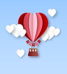 a red hot air balloon floating in the sky with hearts on it's tail