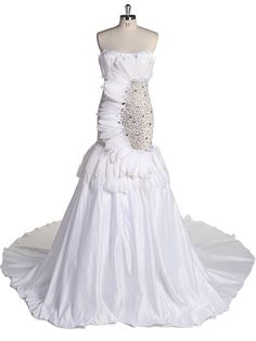 a white wedding dress on a mannequin with ruffles and beading