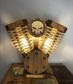 a wooden light with a skull on it and some lights in the shape of wings