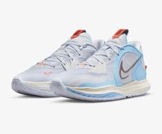 the nike zoom basketball shoe is shown in white, blue and orange with red accents