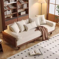 a living room filled with furniture and a book shelf