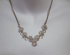 "1980's vintage sterling silver roses with marcasites Art Deco style necklace The setting is rhodium plated, but the chain does not appear to be The roses are 4 inches across, each is about 3/4\" long this piece is marked \"sterling\" on the back of the center rose excellent condition" Formal Silver Jewelry With Rose Details, Silver Rose Design Necklace For Anniversary, Vintage Silver Necklace With Rose Design, Vintage Silver Jewelry With Roses, Vintage Silver Necklaces With Rose Design, Silver Rose Design Metal Necklace, Silver Metal Necklace With Rose Design, Silver Rose Design Necklace, Silver Necklaces With Rose Design For Party