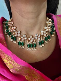 A perfect piece for your next wedding occasion! Adorn yourself with this gorgeous Kundan Jewellery piece. Handcrafted by our skilled Indian craftsmen from Jaipur  Length of earrings: 6 cms Materials: Brass Copper mix, kundan stones, green beads, gold plated  It can be worn both as a necklace and a choker. The necklace and earrings are the same as shown in the pictures. We have only one piece in this color and design, hence you get what you see in the pictures. Temple Style Emerald Necklace With Tilla For Wedding, Wedding Emerald Necklace In Temple Jewelry Style, Traditional Round Emerald Necklace For Wedding, Temple Jewelry Emerald Necklace With Tilla For Wedding, Traditional Emerald Necklace With 17 Jewels For Wedding, Traditional Green Necklace For Anniversary, Green Temple Jewelry Necklace For Anniversary, Traditional Green Necklaces For Anniversary, Festive Hand-set Emerald Necklace For Wedding