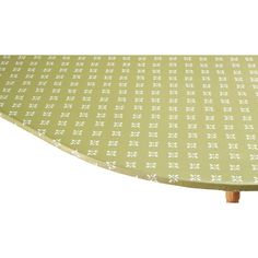 an ironing board cover with white flowers on green and white fabric, set against a white background