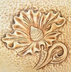 a close up view of a decorative flower on a white surface with an intricate design in the center