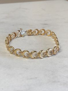 "14kt Yellow Gold Lady's Diamond 7\" Bracelet consisting of 22 full cut round brilliant diamonds 1/2ct total weight SI2 clarity, H color all set in 4 prong low base heads soldered inside bright polished custom made circles all hinged for maximum flexibility and comfortable movement. This well made diamond bracelet has a heavy hidden style clasp. You can be proud to wear this day after day either casual or formal for a grandeur look of elegance. The weight of the bracelet is 12.15 grams. This ite White Gold Bracelet With Diamond Accents, Timeless Round Gold Bracelet With Cubic Zirconia, Anniversary Yellow Gold Diamond Bracelet With Prong Setting, Classic 14k Gold Diamond Bracelet, 14k Gold Bracelet For Anniversary, 14k Gold Diamond Bracelet With Prong Setting, 14k Gold Bracelet With Diamond Accents, Diamond White 14k Gold Diamond Bracelet, 14k Gold Anniversary Bracelet