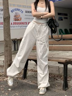 Features: These White Y2K Cargo Pants are a versatile piece that combines fashion with functionality. With a high waist and loose fit, they offer comfort and style that is perfect for any occasion. The lace-up detail adds a touch of American Harajuku style, making them a must-have addition to any wardrobe. Made with high-quality materials, these pants are durable and long-lasting. Upgrade your wardrobe with these vintage-inspired cargo pants. Baggy Drawstring Wide-leg Pants, Baggy Wide-leg Drawstring Pants, Spring Baggy Wide-leg Cargo Pants, White Baggy Drawstring Pants, Spring Straight Cargo Pants With Loose Fit, Wide Leg Harem Pants With Drawstring For Streetwear, Baggy Wide-leg Pants With Drawstring, Baggy High-waisted Cargo Pants For Spring, Chic Wide Leg Parachute Pants For Streetwear