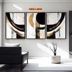 a living room with three paintings on the wall