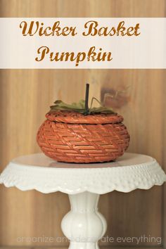 a wicker basket pumpkin sitting on top of a white cake stand with text overlay