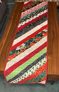 a wooden table with a colorful quilt on it