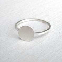 The Tiny Silver flat disk Ring is perfect for everyday wear. The design of this ring is very elegant and simple. The ring has a smooth, matte finish and the width of the band is 1 mm. The tiny flat disk has a diameter of 7mm. This ring is a perfect for stacking. Package in a brown kraft box. O U R ∙ P O L I C I E S http://etsy.me/3Q4WBQs M O R E ∙ F R O M ∙ U S https://virginiawynne.etsy.com www.virginiawynnedesigns.com https://www.facebook.com/VirginiaWynneDesigns Follow us on Instagram @virgin Silver Minimalist Rounded Signet Ring, Silver Minimalist Signet Ring, Simple Sterling Silver Signet Ring, Minimalist Adjustable White Gold Signet Ring, Adjustable Minimalist White Gold Signet Ring, Simple Sterling Silver Round Signet Ring, Minimalist White Gold Signet Ring, Silver Minimalist Stackable Rings, Minimalist Sterling Silver Stackable Rings