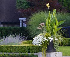 a planter with flowers in it sitting on the ground