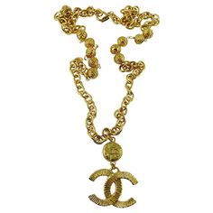 CHANEL vintage gold toned chain necklace featuring a ribbed textured CC logo pendant topped by a CHANEL coin. Spring clasp closure. IMPORTANT INFORMATION : The spring of the clasp is not perfectly functional - it needs to be pushed manually in order to close. That is said, once the clasp is closed it holds perfectly well and you will not need to close and open the necklace as far as it can be slipped around the neck. Embossed Marked CHANEL Made in France. Indicative measurements : chain length a Gold-tone Metal Necklace With Logo Plaque, Gold-tone Metal Chain Necklace With Logo Charm, Gold Chain Necklace With Gold-tone Logo, Gold Chain Necklace With Logo Plaque, Vintage Jewelry With Gold-tone Logo Plaque, Gold Metal Necklaces With Gold-tone Logo Plaque, Vintage Gold Necklace With Gold-tone Logo Plaque, Vintage Metal Necklace With Logo Charm, Vintage Gold-tone Necklace With Logo Charm