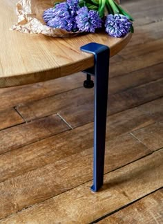 a wooden table with purple flowers on it