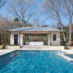 an outdoor pool with a gazebo next to it