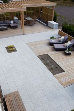 an aerial view of a patio with couches, tables and grills in the background