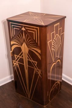 a wooden cabinet with art deco designs on it