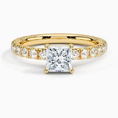 a yellow gold engagement ring with diamonds on the band