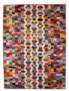 a quilt made with many different colors and patterns