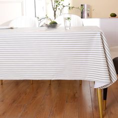 a dining room table with a striped cloth on it