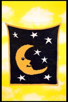 a black and yellow wall hanging with stars on it