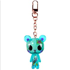 a keychain with a blue bear on it's face and a chain attached to it