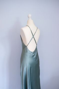 Size: XS - Bust 77 - 79cm - Waist 60 - 62cm - Hip 83 - 85cm - Front length without straps 105cm - color: mystical green   - very simple yet classy and elegant evening dress - wide open back design with adjustable straps - bias-cut design allows the beautiful flare and nuances  - a perfect addition for your minimalistic, refined wardrobe - 100% handmade in Germany with care and adoration, supporting you to uplift your energy and self-loving consciousness Made with 100% mulberry silk charmeuse - Grade 6A - Mulberry silk - 19 momme - OEKO-TEX® certified material Wash care information - Dry cleaning - Cool hand wash - Iron on reverse side - Do not bleach - No tumble dry -No fabric softner Fitted Silk Backless Slip Dress, Fitted Satin Slip Dress With Low Back, Green Slip Dress With Spaghetti Straps And Bias Cut, Green Bias Cut Slip Dress With Spaghetti Straps, Green Silk Evening Slip Dress, Green Silk Slip Dress For Evening, Fitted Satin Slip Dress With Back Opening, Backless Satin Finish Slip Dress, Green Silk Slip Dress For Formal Occasions